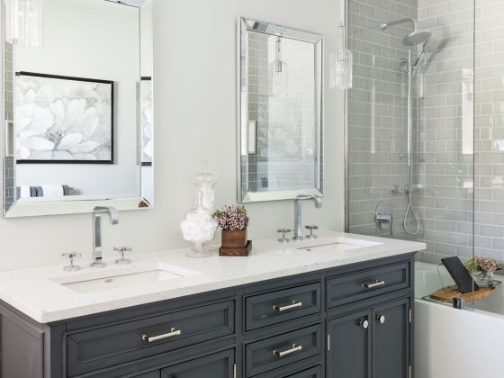 Vanity cover with black cabinetry and white countertops