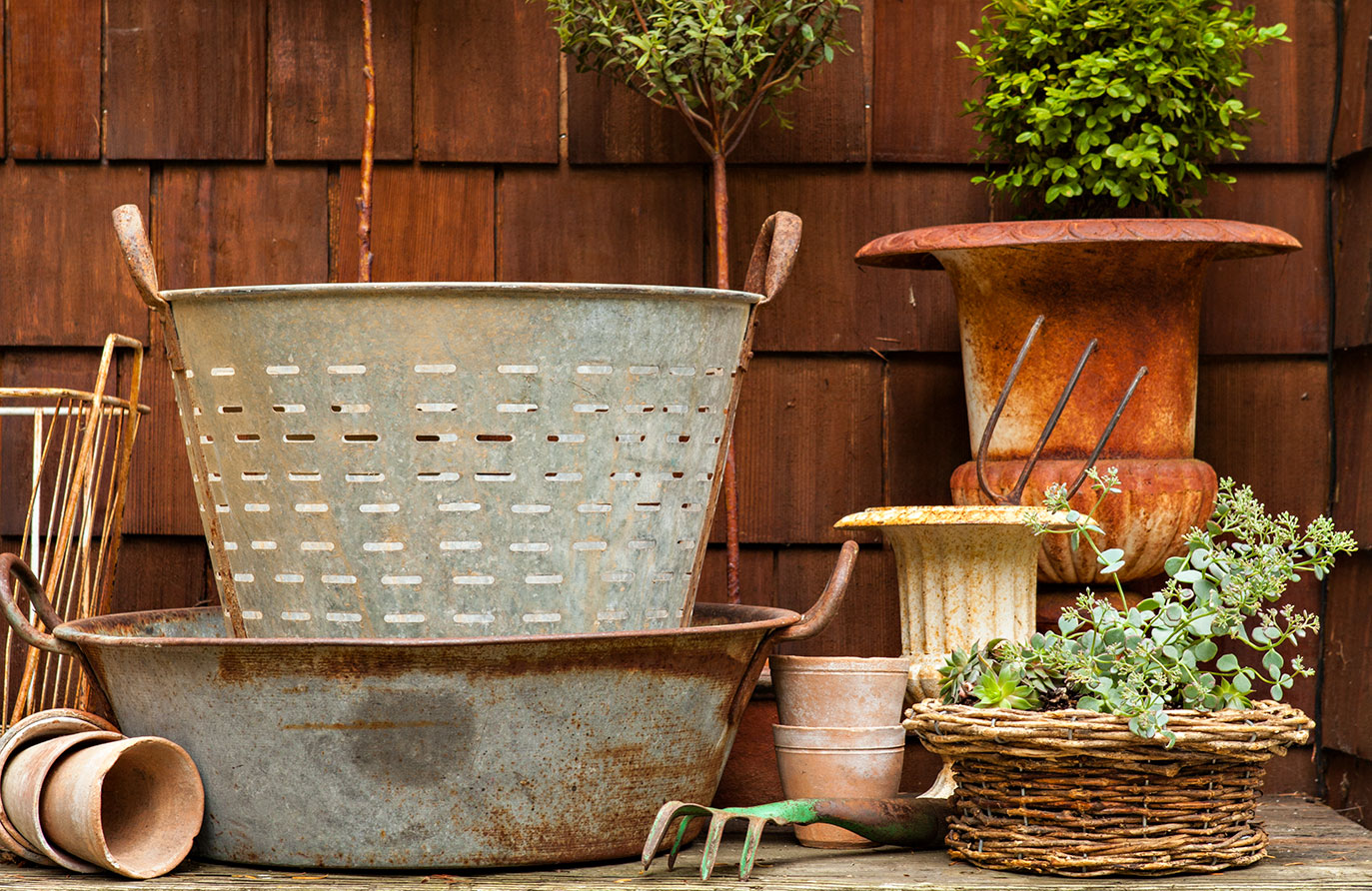 potting bench with vintage olive buckets