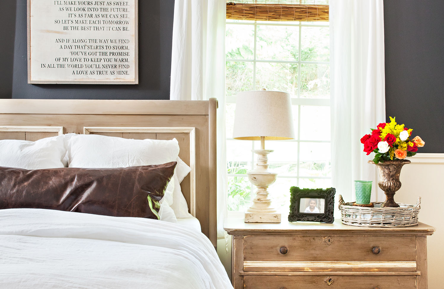 farmhouse bedroom with word art above the bed