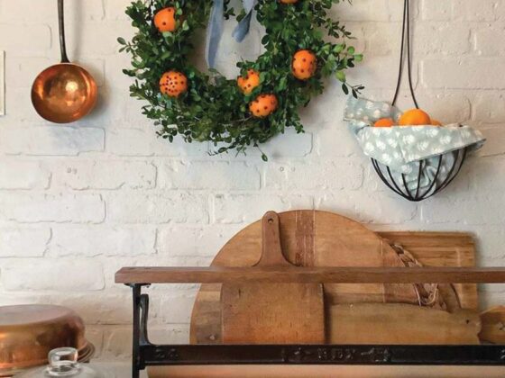 homemade boxwood wreath with oranges and cloves in cottage pantry