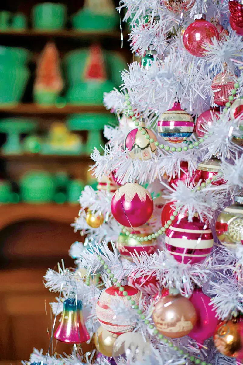 white faux tree with vintage ornaments and mint green bead garland