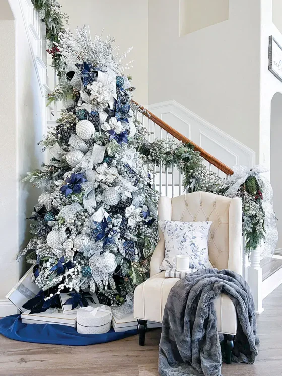 blue and white tree in foyer of Nissa-Lynn's magical holiday home