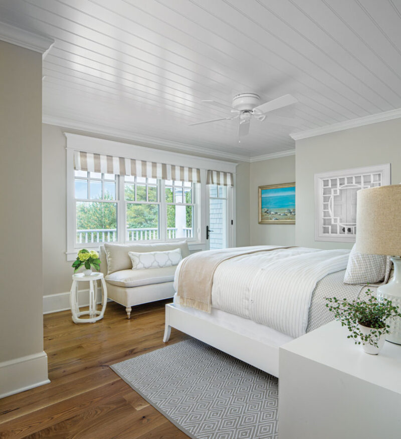 guest bedroom with large picture windows and sand inspired color palette