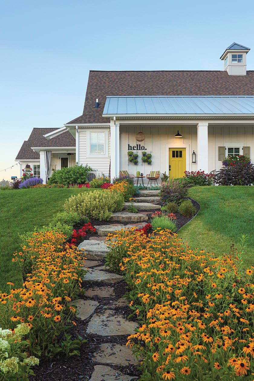 black-eyed Susans and stone pathway to barn